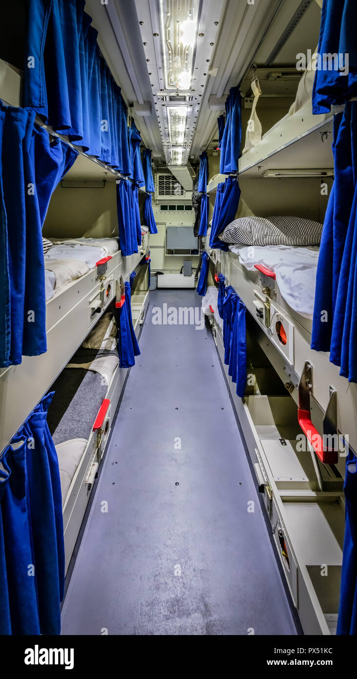 A wide angle shot of the tight quarters of a berthing compartment of a ship. Stock Photo