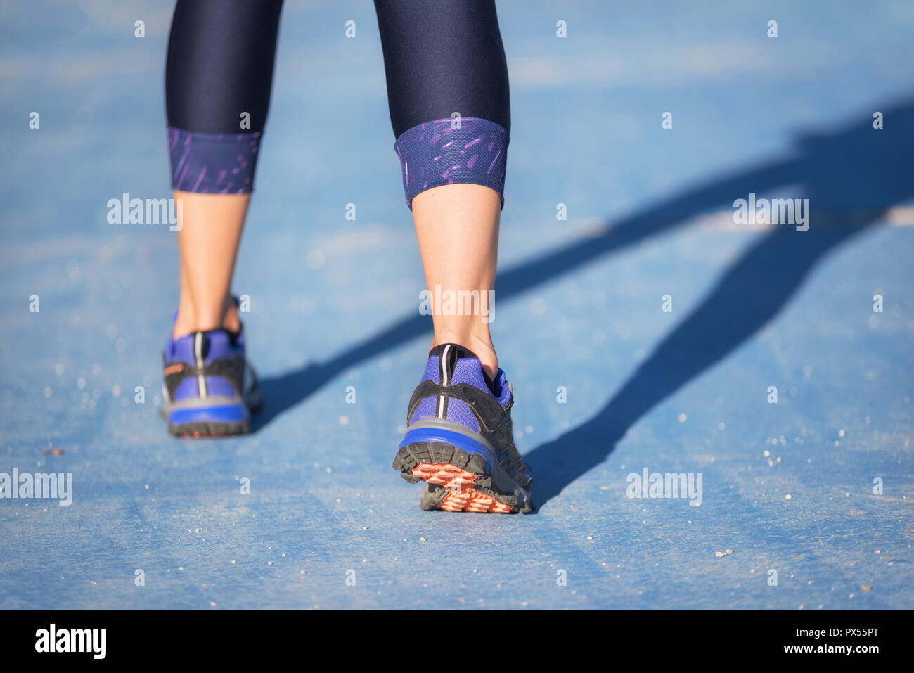Runner feet running closeup on shoe. woman fitness jog workout welness concept. Stock Photo
