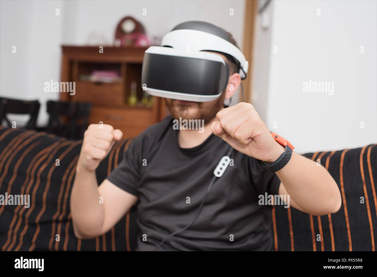 Bearded man wearing virtual reality goggles Stock Photo