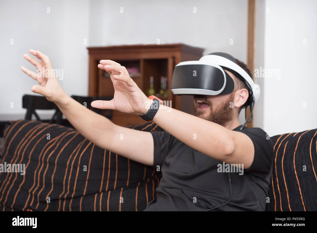 Bearded man wearing virtual reality goggles Stock Photo