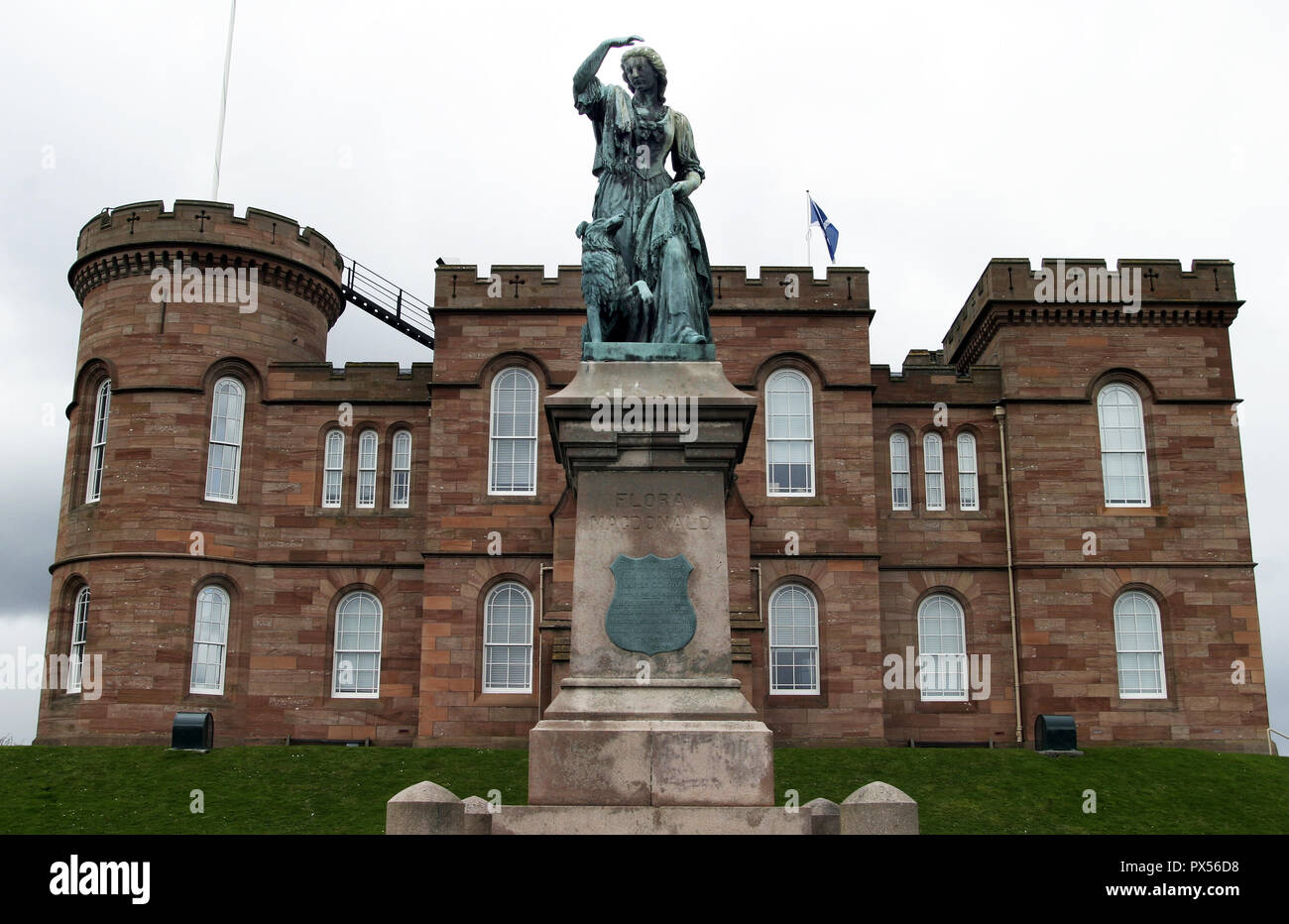 A statue of Flora MacDonald sits outside Inverness Castle and overlooks the city from there. She helped Bonnie Prince Charlie flee Scotland after his defeat at the Battle of Culloden in 1746. Stock Photo