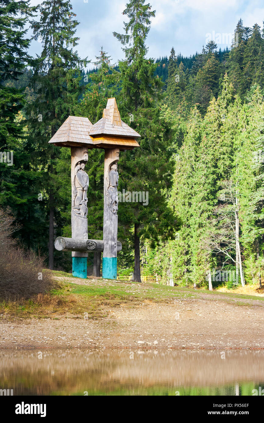 Synevyr, Ukraine - OCT 19 2013: statue of Syn and Vyr on the shore of a lake in forest Stock Photo