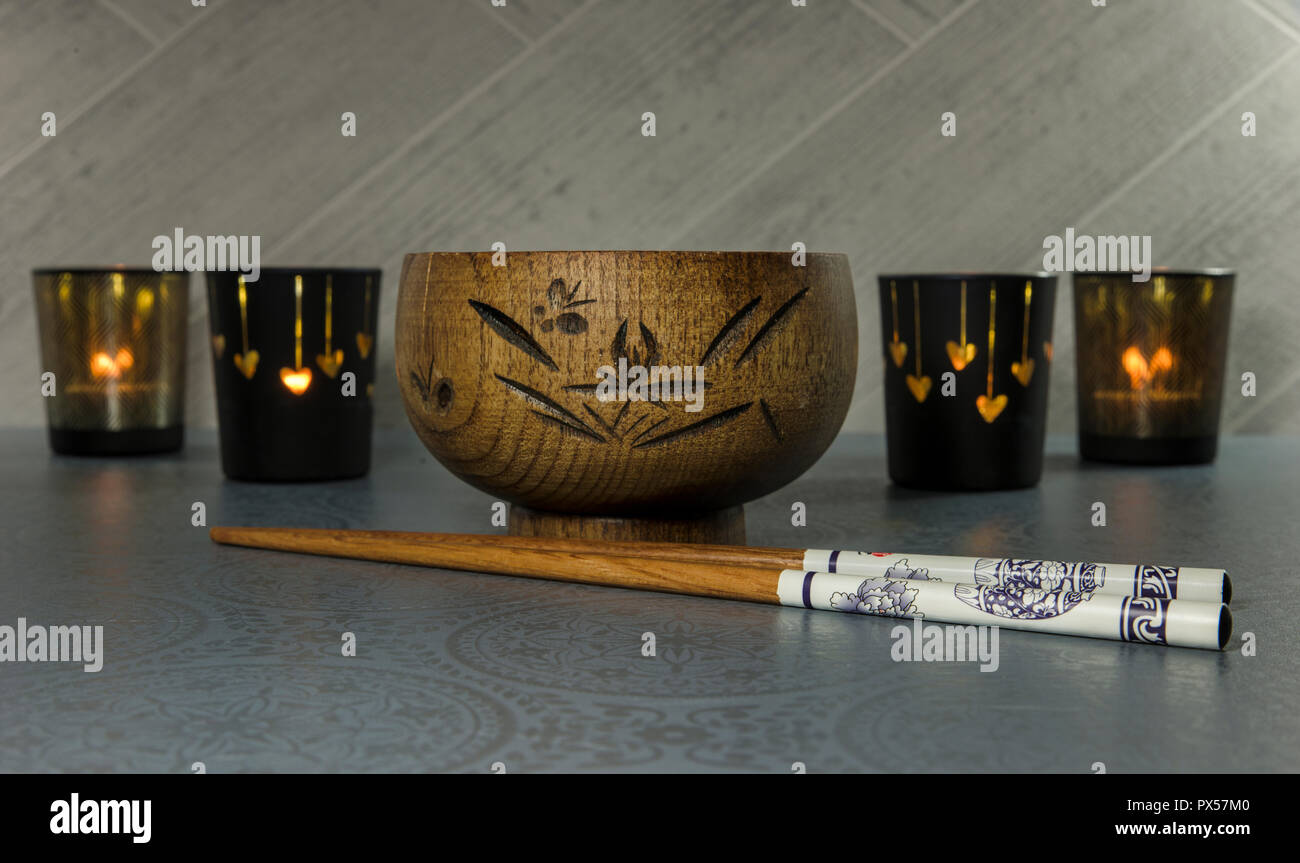 japanese or chines chopsticks with bamboo wooden rice bowl and light at the background Stock Photo