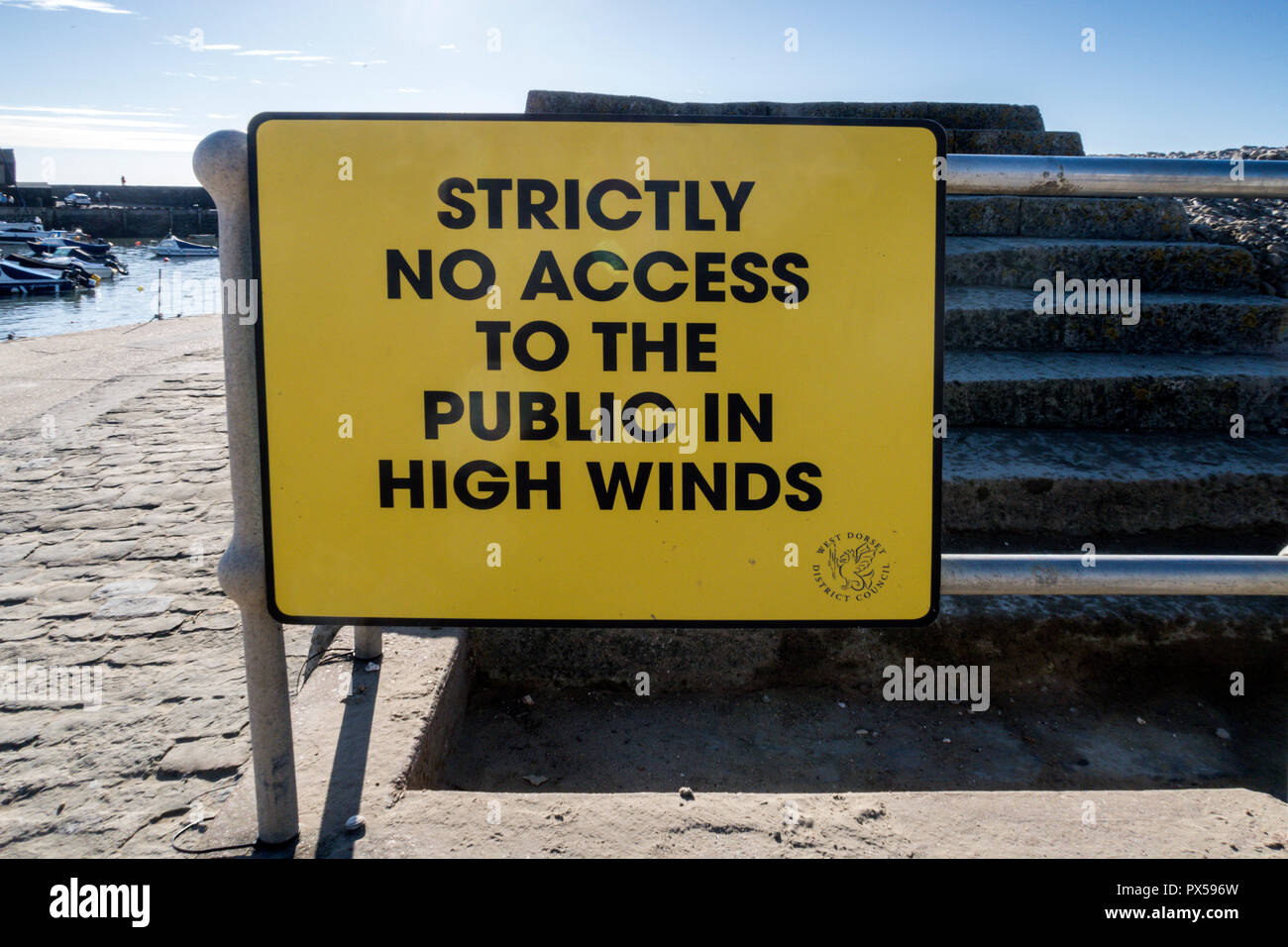 Sign, notice, no access in high winds, on the Cobb atLyme Regis, Dorset, UK Stock Photo