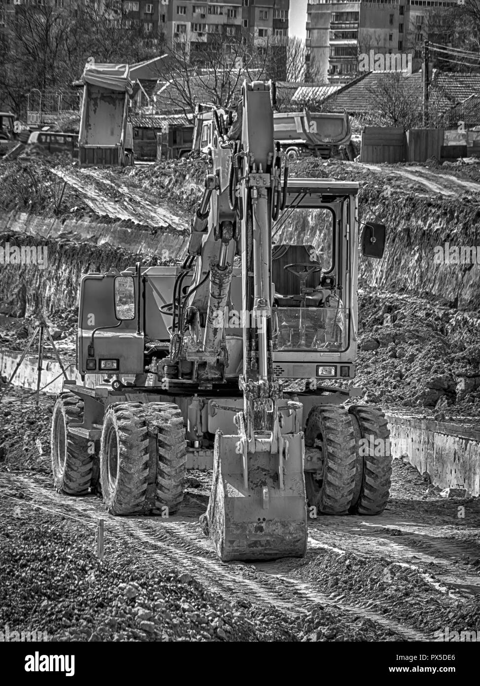 Amazing black and white view of the stopped excavator at the construction site Stock Photo