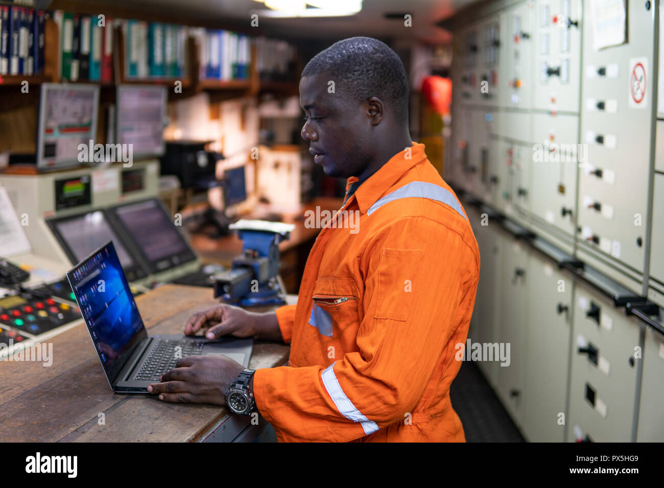 Marine engineer officer working in engine room Stock Photo Alamy