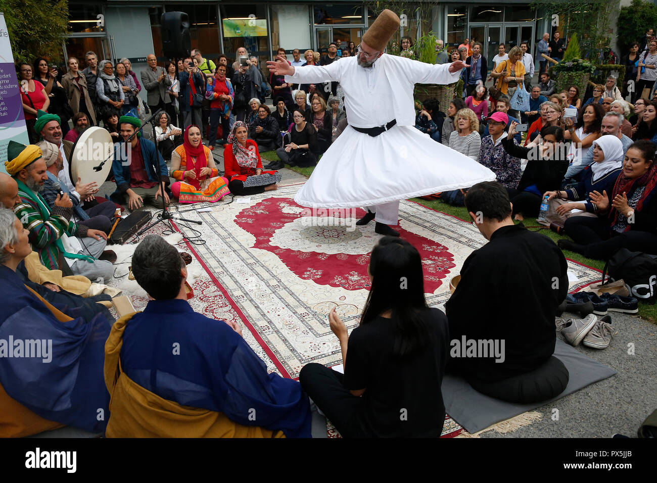 Zen buddhists and muslim sufis praying and celebrating together at the Salon Zen, Paris, France. Whirling dervish. Stock Photo