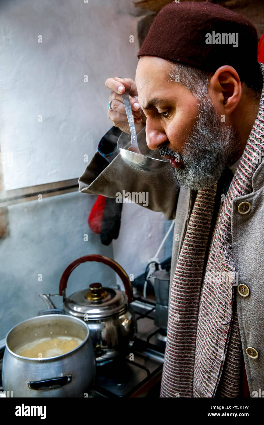 Sufi preparing a meal in Romilly, France. Stock Photo