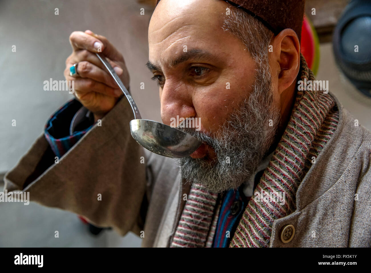 Sufi preparing a meal in Romilly, France. Stock Photo