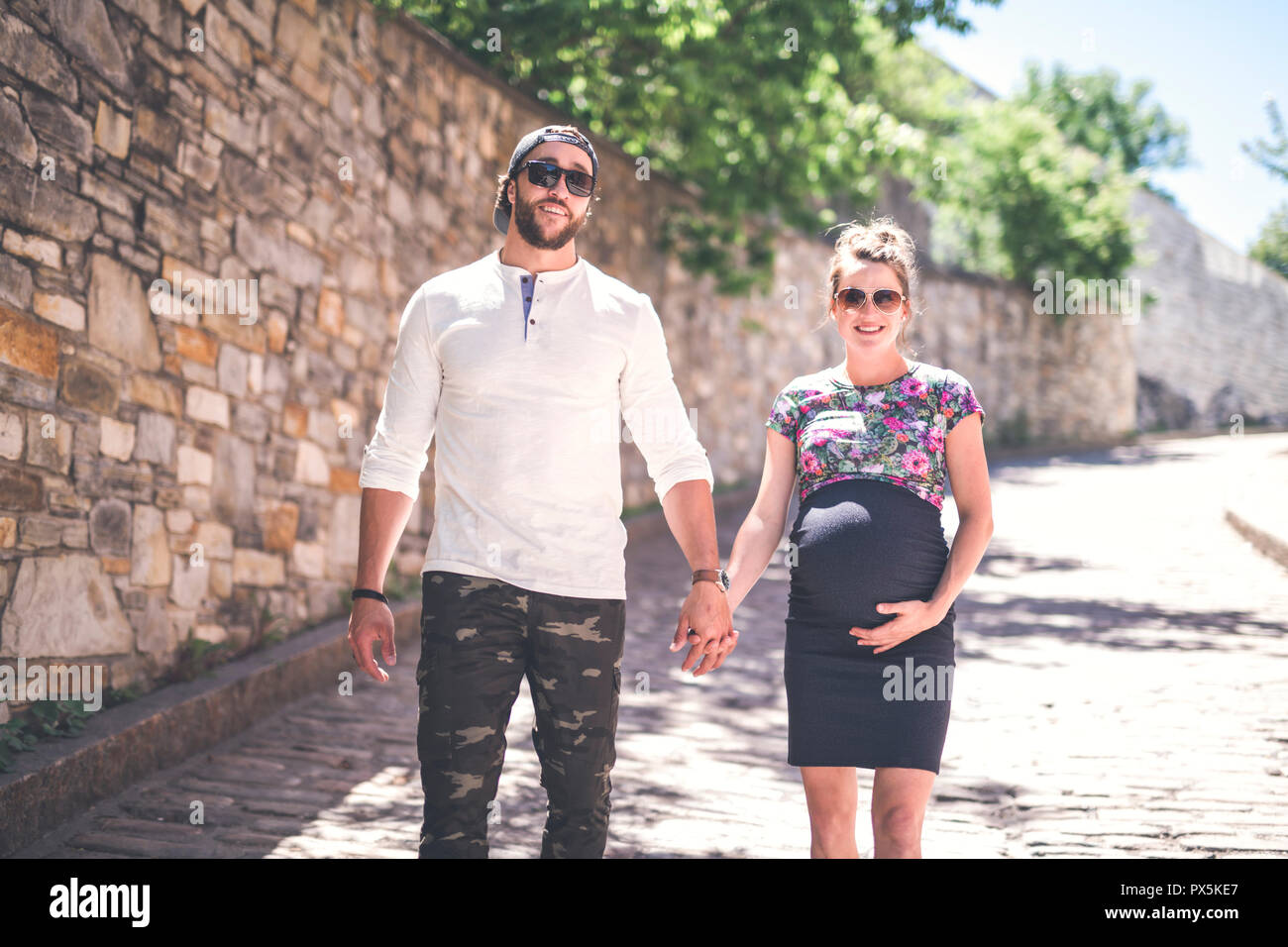 A Pregnant couple portrait outside in the neighborhood Stock Photo