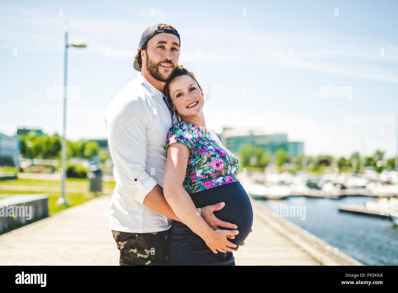 A Pregnant couple portrait outside in the neighborhood Stock Photo