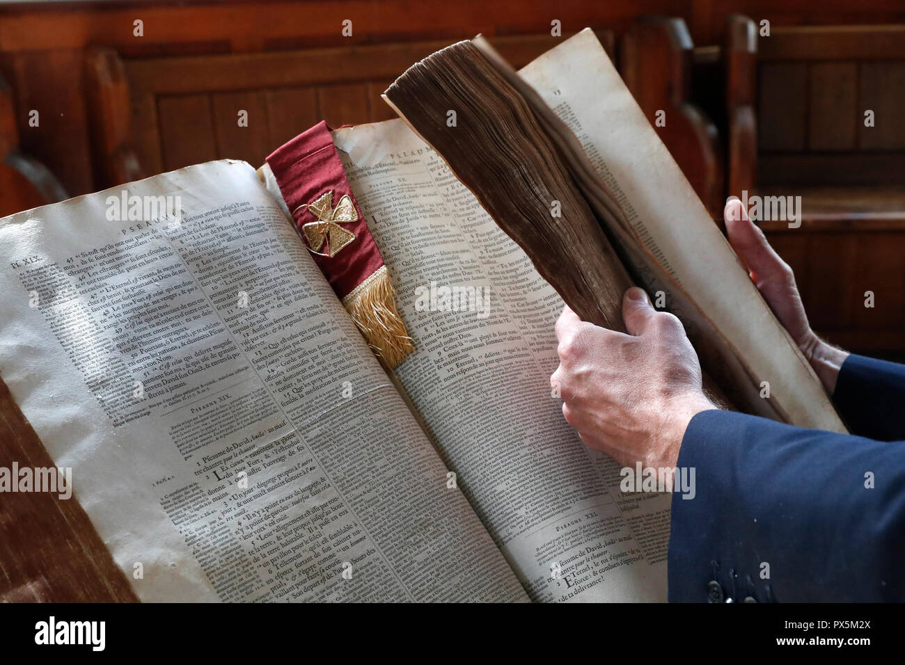 Old bible in French, 1669. Man reading the bible. Stock Photo