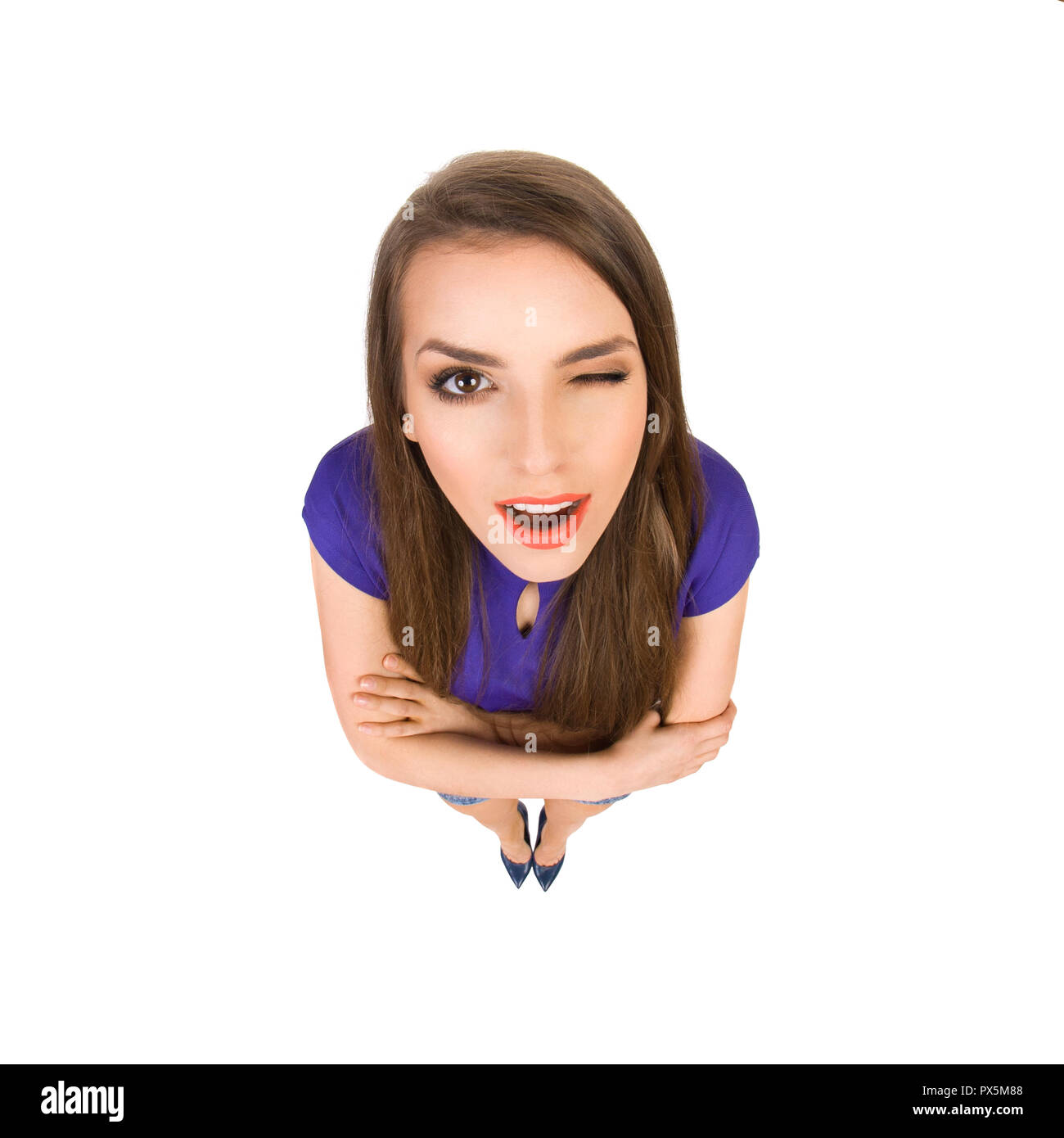 Young beautiful woman is standing with arms crossed, looking at camera