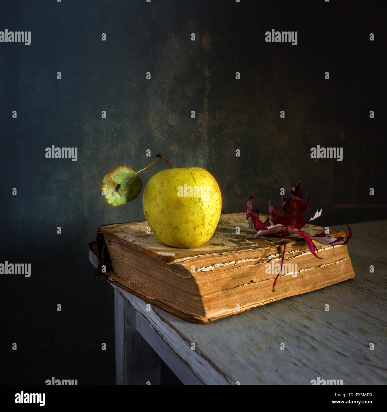 Still life with a book, an apple and a maple leaf. vintage Stock Photo