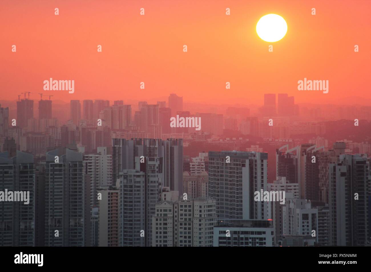 Sunset over a big asian city Stock Photo