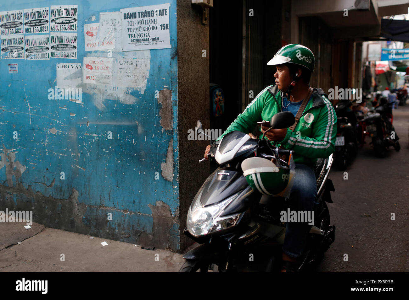 Moto taxi. Grab driver.  Ho Chi Minh City. Vietnam. Stock Photo