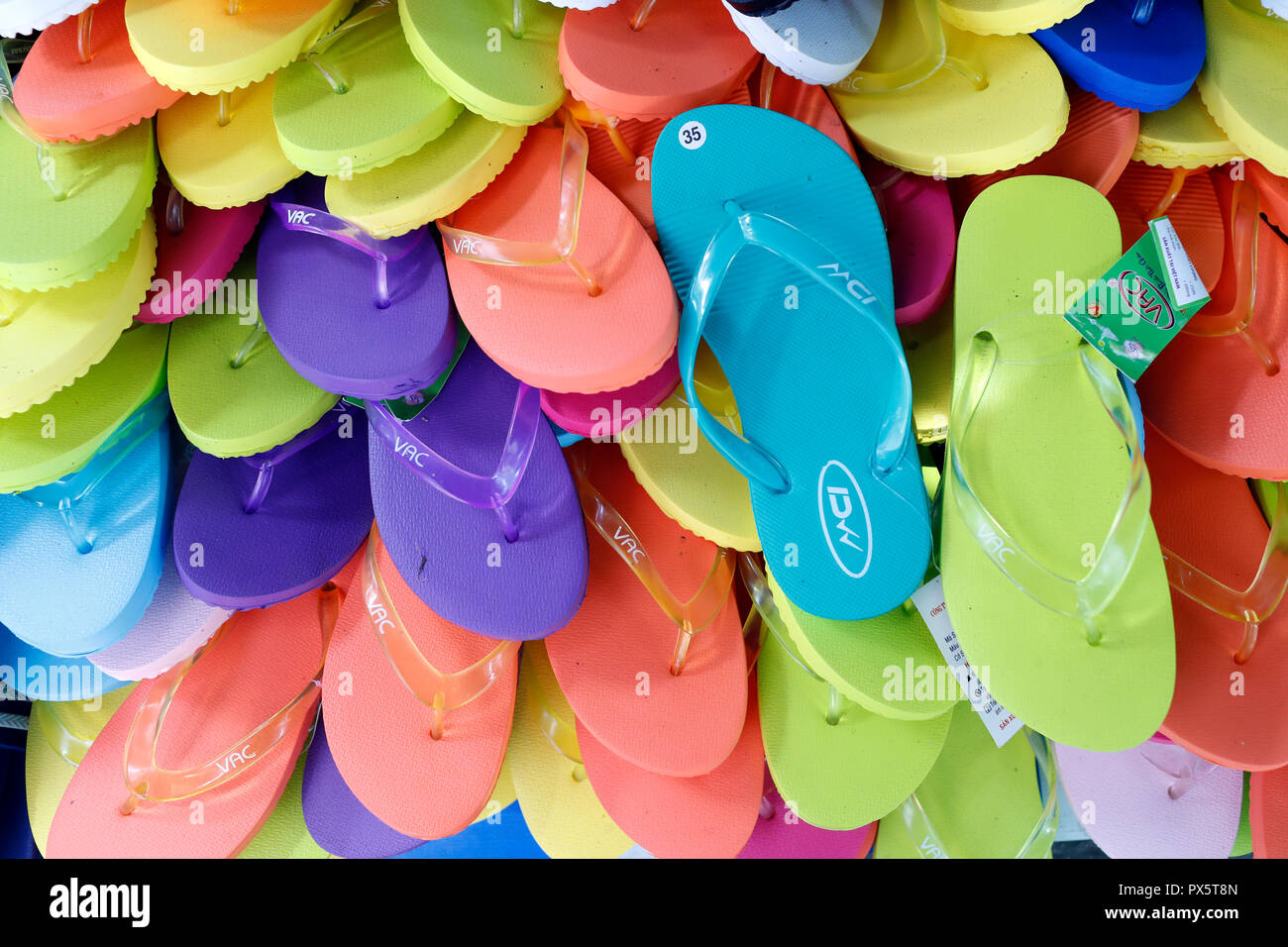 Multicolored flip flops at market. Cai Be. Vietnam. Stock Photo