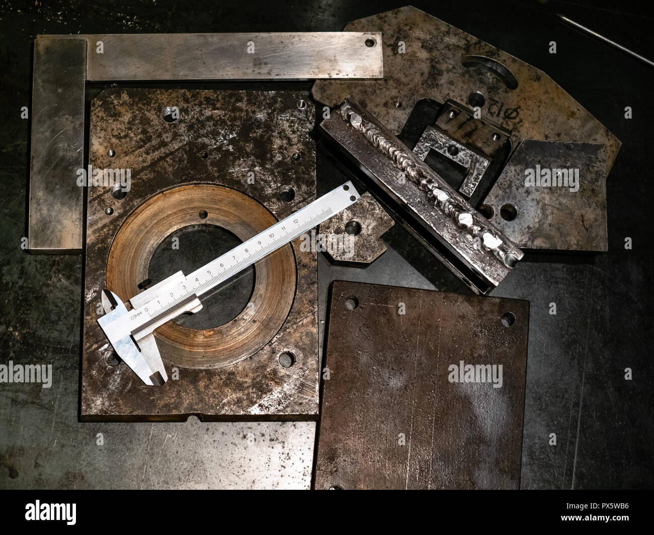 Metalworking still life - top view of steel calipers on metal workbench in turnery workshop Stock Photo