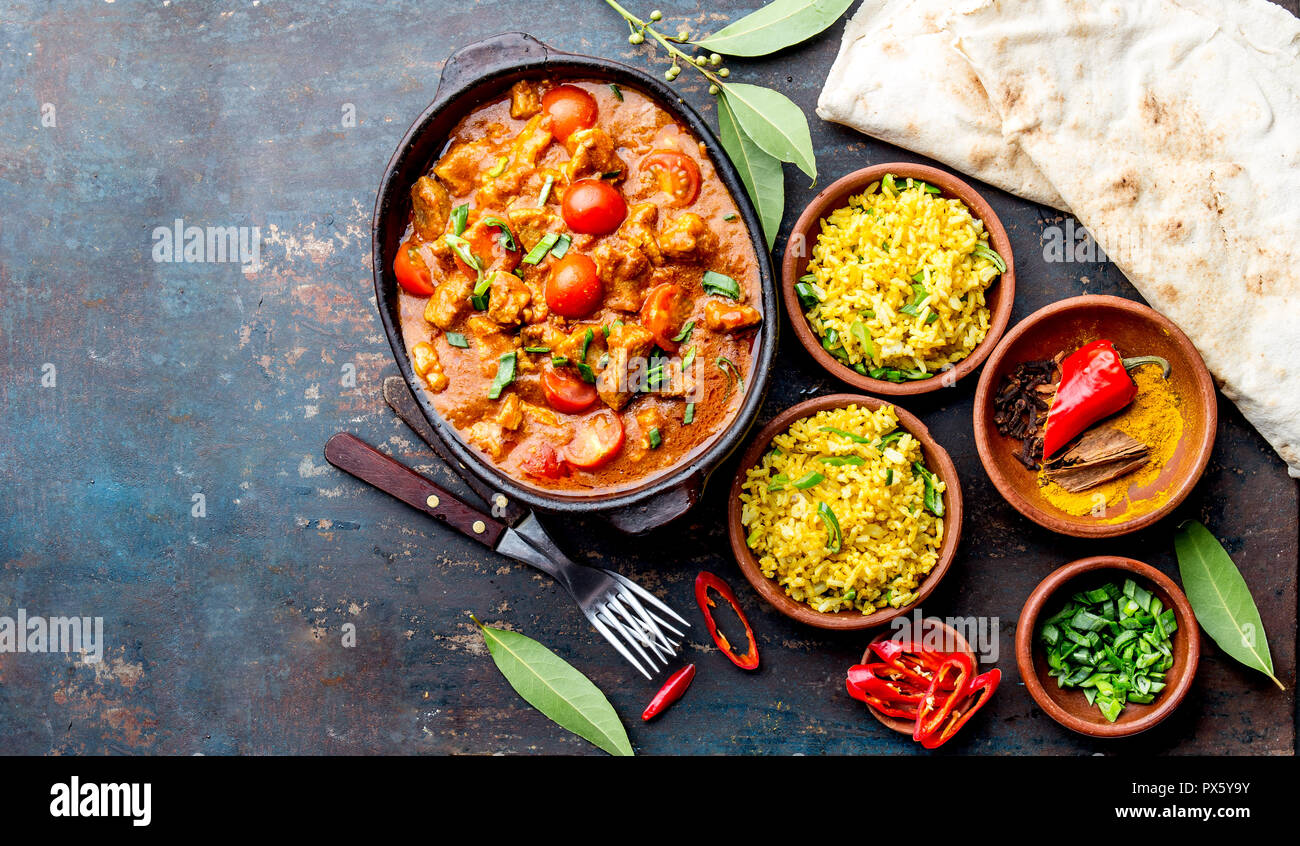 INDIAN FOOD. ROGAN JOSH curry sauce. Pork rogan josh with rice and naan
