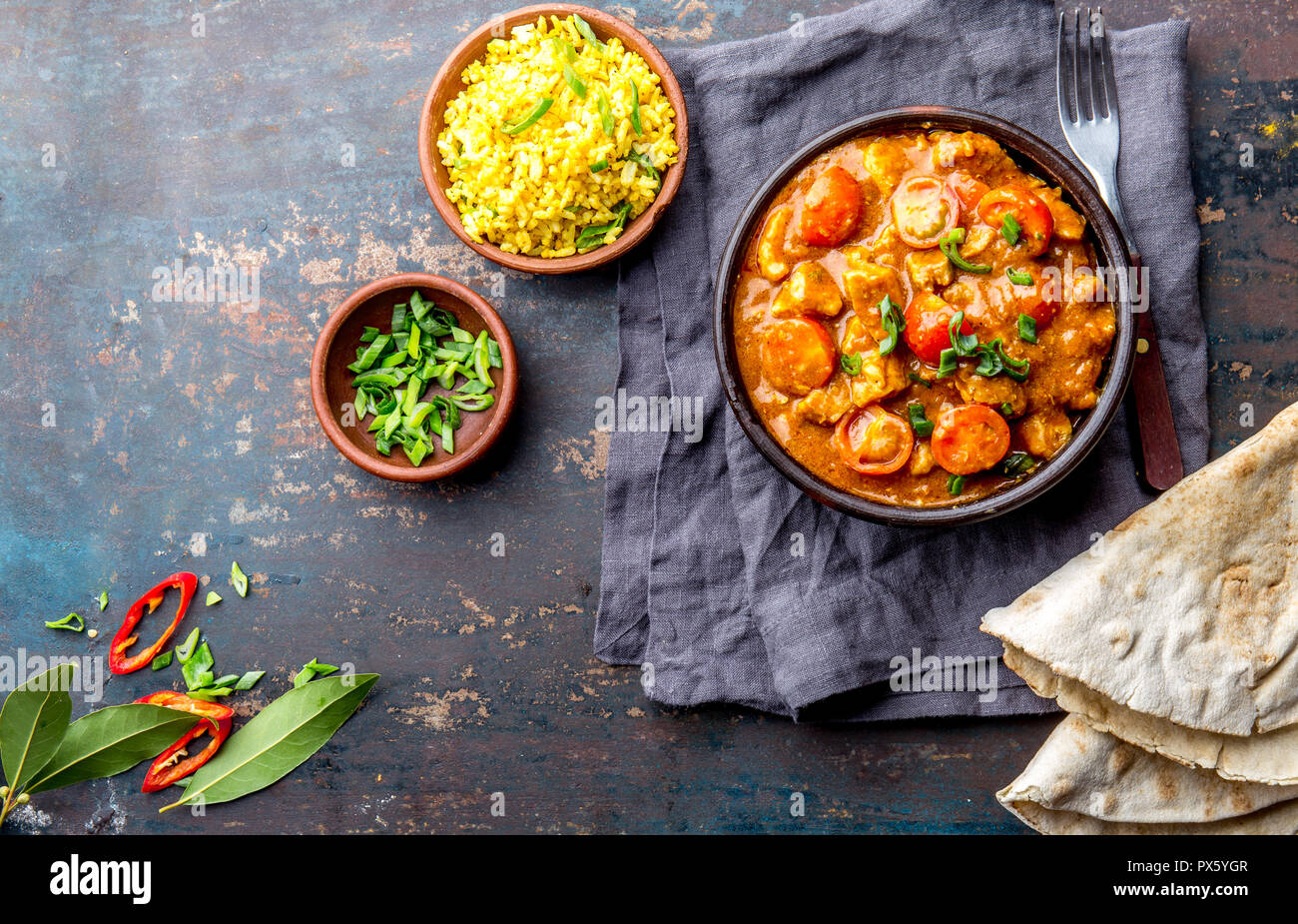 INDIAN FOOD. ROGAN JOSH curry sauce. Pork rogan josh with rice and naan
