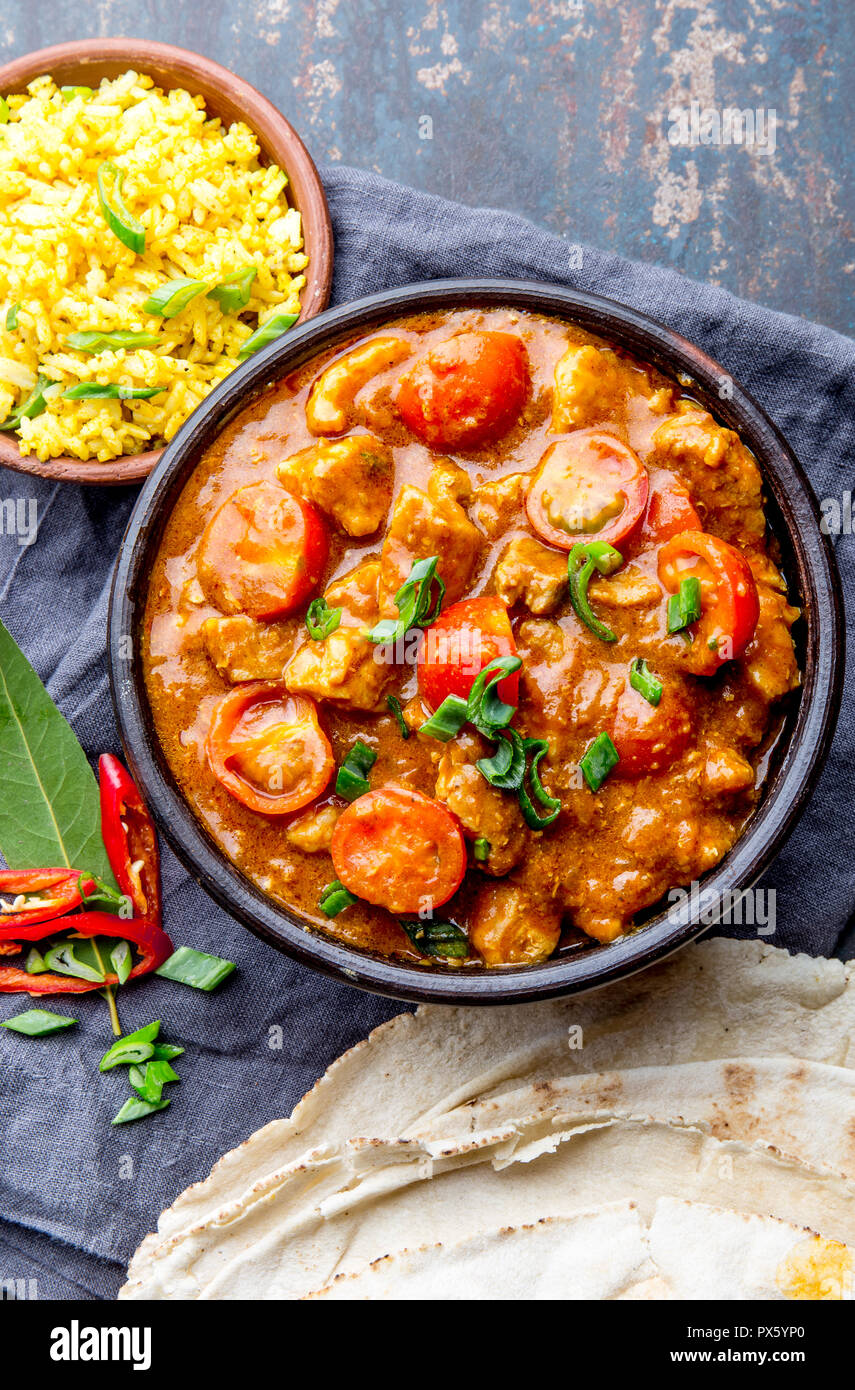 INDIAN FOOD. ROGAN JOSH curry sauce. Pork rogan josh with rice and naan