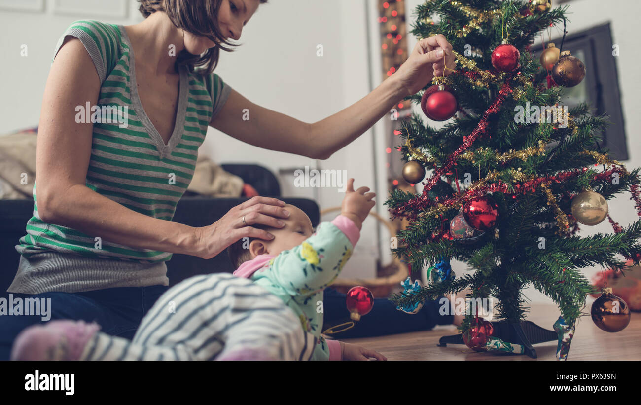 Retro image of a young mother sitting on a floor with her baby daughter