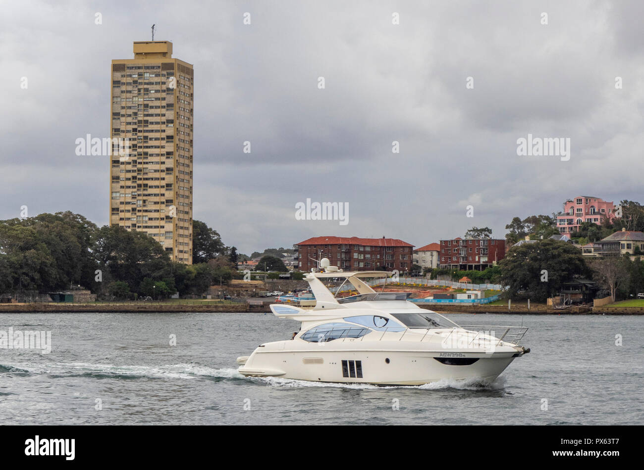 A speed boat on Sydney Harbour and Harry Seidler Blues Point Tower on   Lavender Bay Sydney NSW Australia. Stock Photo