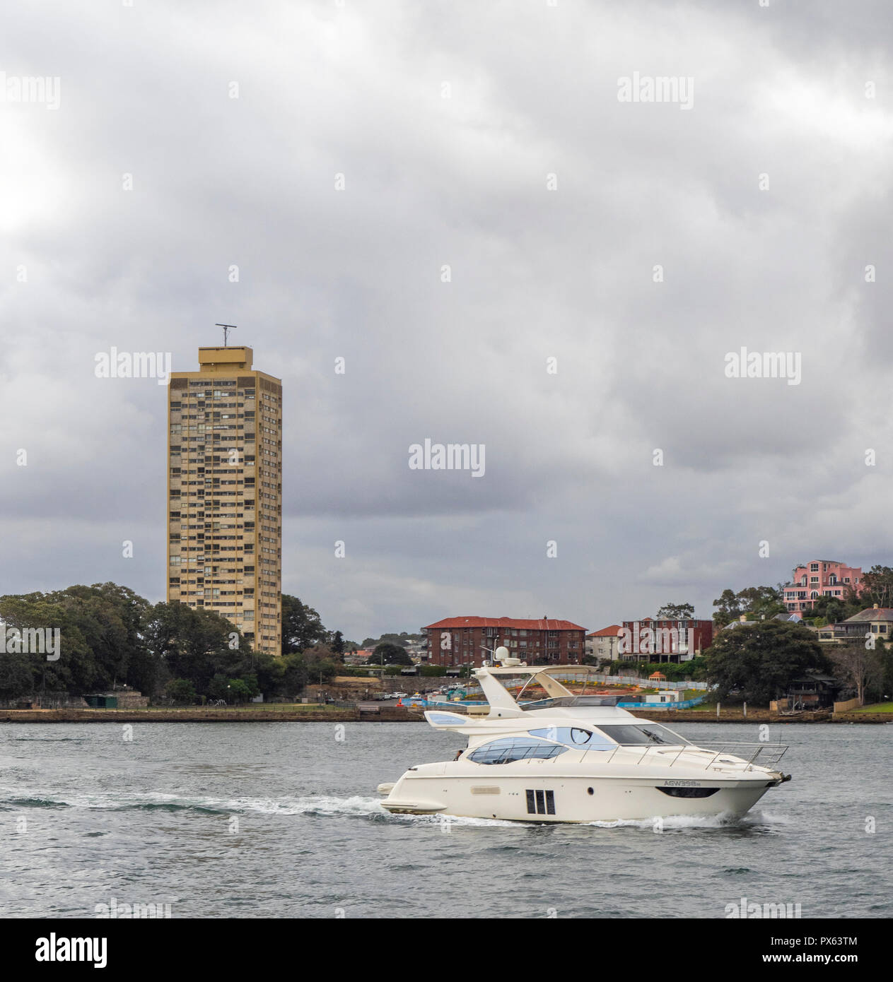 A speed boat on Sydney Harbour and Harry Seidler Blues Point Tower on   Lavender Bay Sydney NSW Australia. Stock Photo