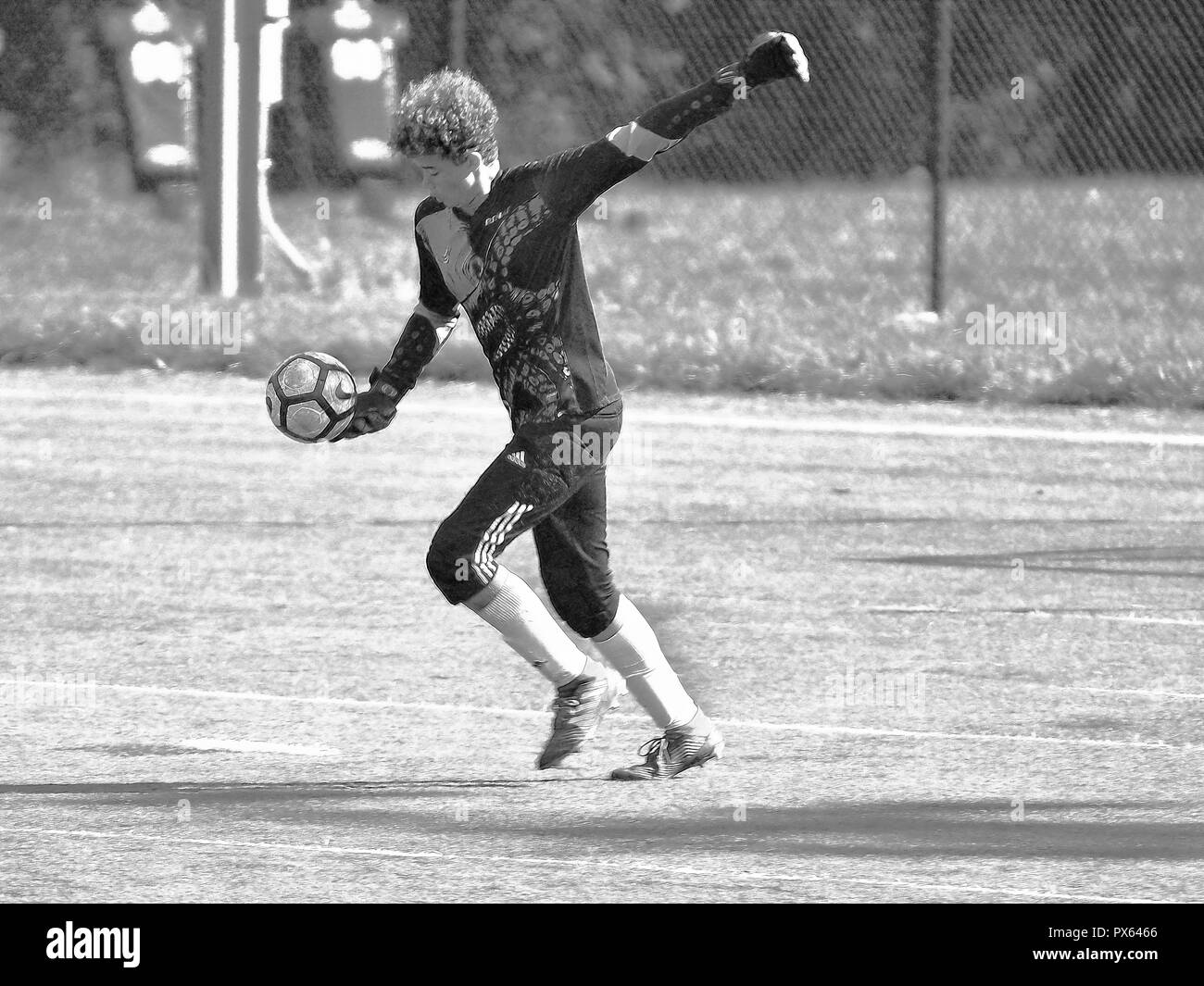 BW Illustration of young soccer goalie about to kick ball Stock Photo