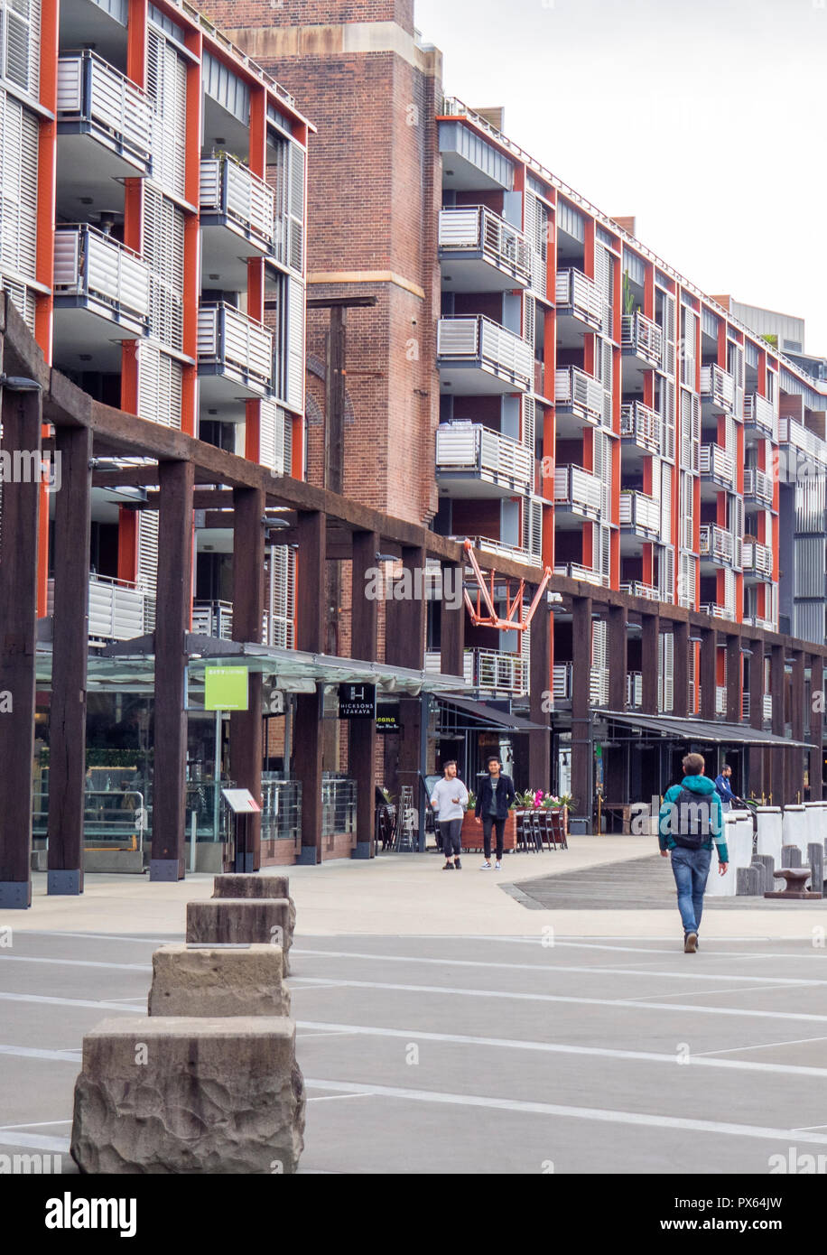 Pedestrians walking along the boardwalk in high density residential development in Walsh Bay