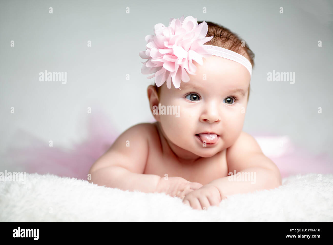 Adorable little baby girl crawling on the floor wearing tutu skirt Stock Photo