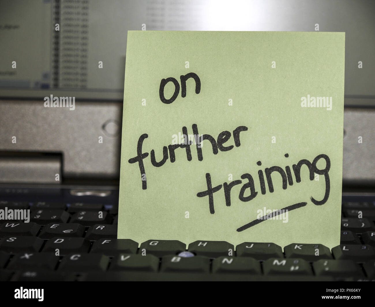 Memo note on notebook, on further training Stock Photo