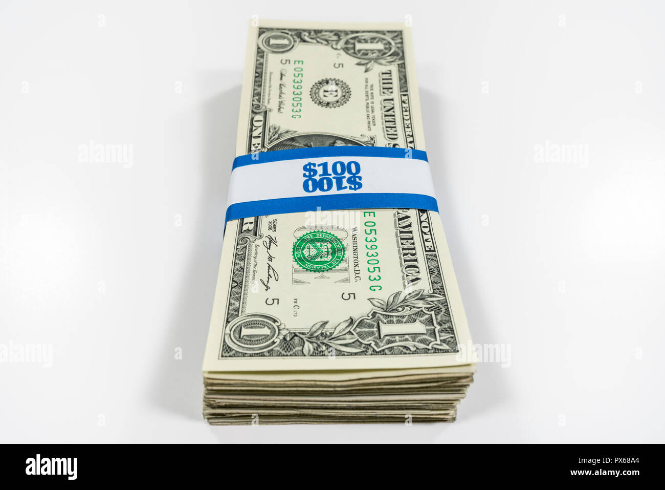 Stack of one dollar bills with $100 paper currency strap. Stock Photo