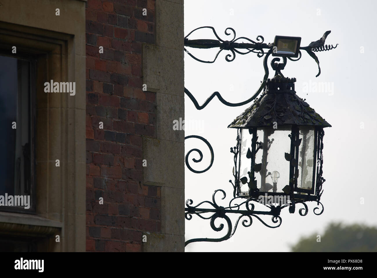 Old gas lantern, now an electric lantern, on a corner wall of Sandringham House, the Monarch's country residence at Norfolk, England. Stock Photo
