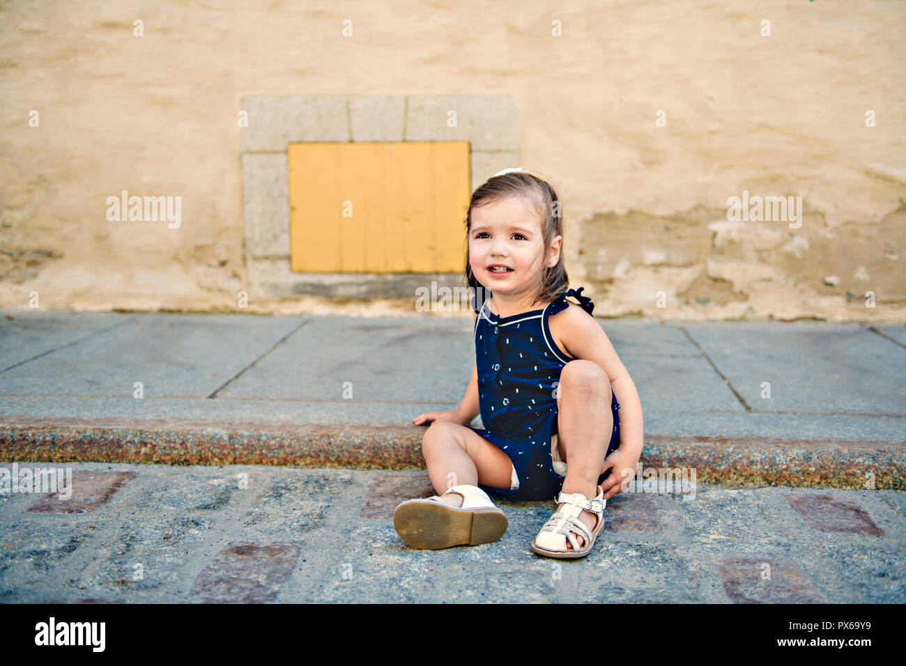 A two years old child girl on urban street Stock Photo Alamy