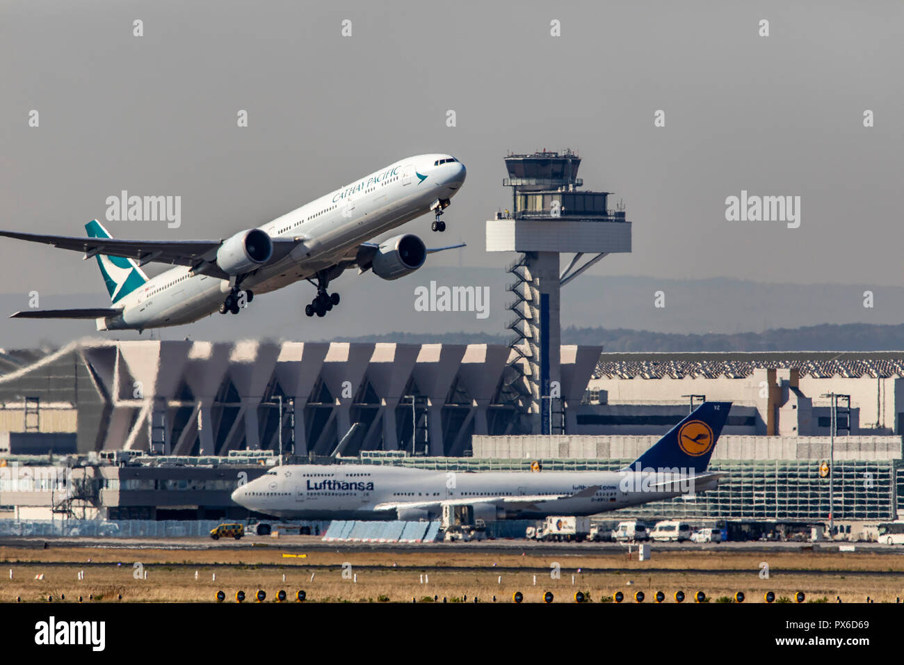 Frankfurt / Main Airport, FRA, Fraport, Lufthansa Boeing 747 on the taxiway, Cathay Pacific Boeing 777, at take-off, Air Traffic Control Tower, Stock Photo