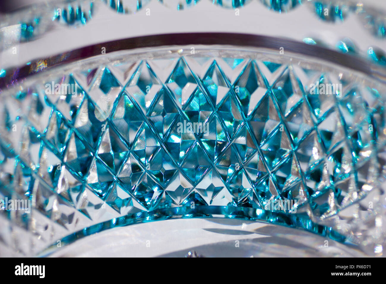 Macro background view of beautiful lead crystal glass with hand-cut diamond  pattern facets reflecting brilliant aqua blue color Stock Photo - Alamy