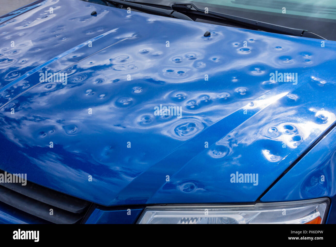 Severe hail damage to the hood of automobile, Aurora Colorado USA. Storm occurred in July 2016. Stock Photo