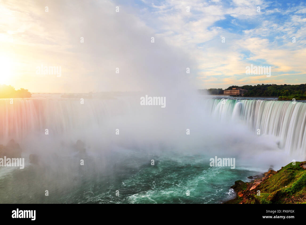Morning sunrise over Horseshoe Falls at Niagara Falls in Ontario, Canada, showing rising mist from the force of the water's plunge. Stock Photo