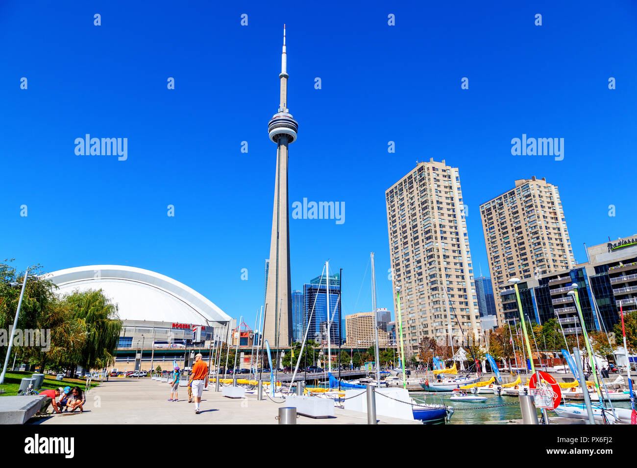 TORONTO, CANADA - AUG 29, 2012: Downtown marina in Toronto with landmark CN Tower, Rogers Centre and city skyline. Stock Photo