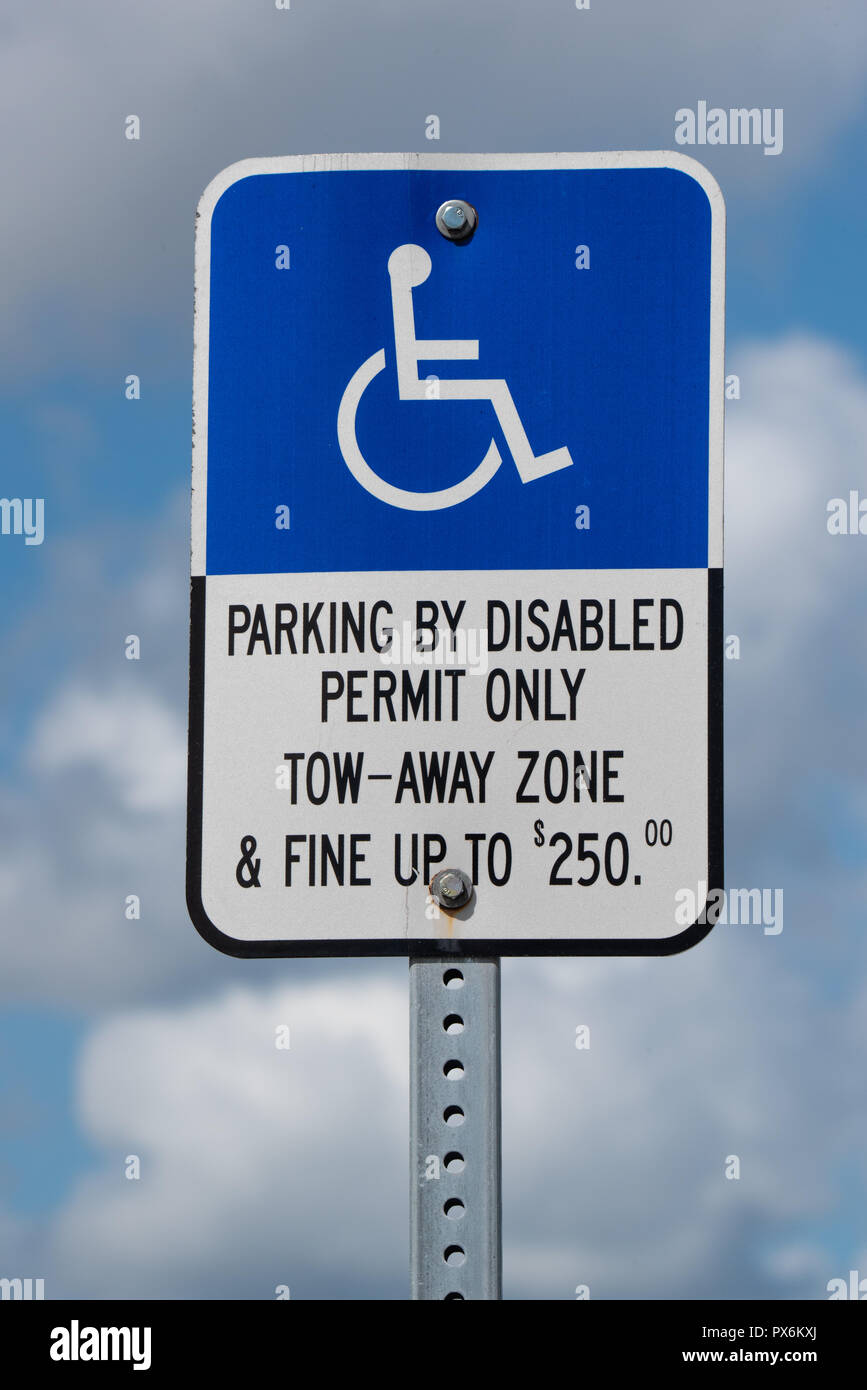 Disabled Parking sign against a cloud sky Stock Photo