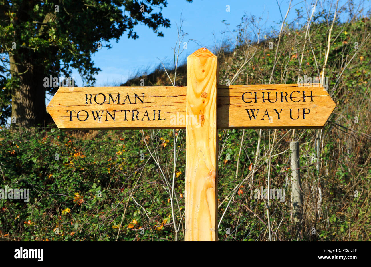 A fingerpost sign on footpath indicating way to Church and Venta Icenorum Roman Town Trail at Caistor St Edmund, Norfolk, England, UK, Europe. Stock Photo