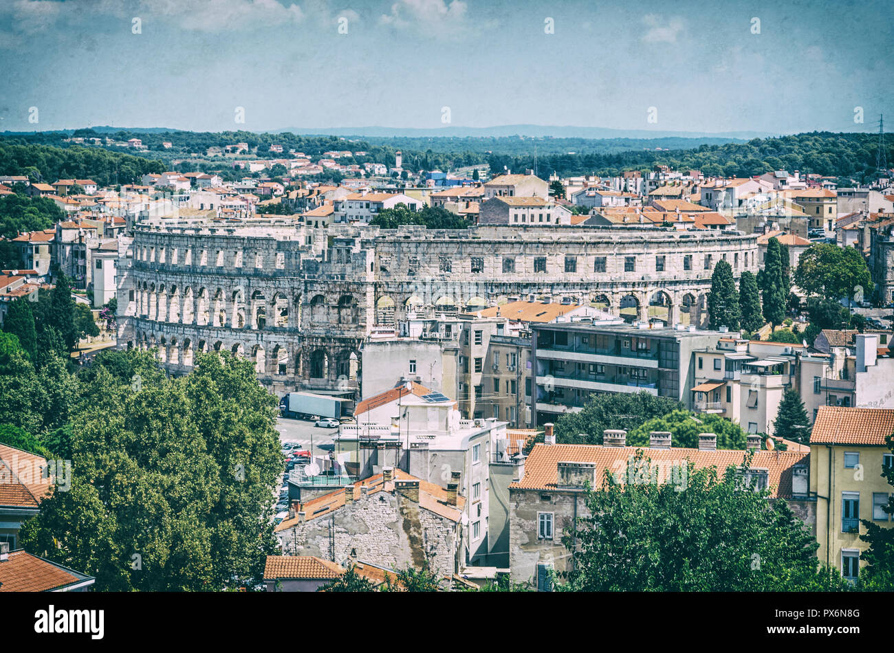 Pula Arena - ancient amphitheater located in Pula, Istria, Croatia. Travel destination. Famous object. Analog photo filter with scratches. Stock Photo