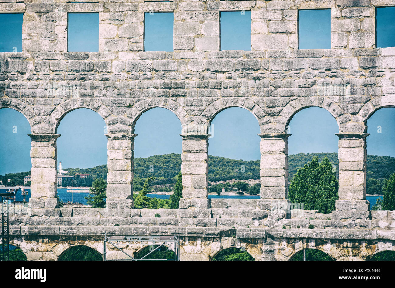 Detail photo of Pula Arena, Istria, Croatia. Travel destination. Ancient architecture. Analog photo filter with scratches. Stock Photo