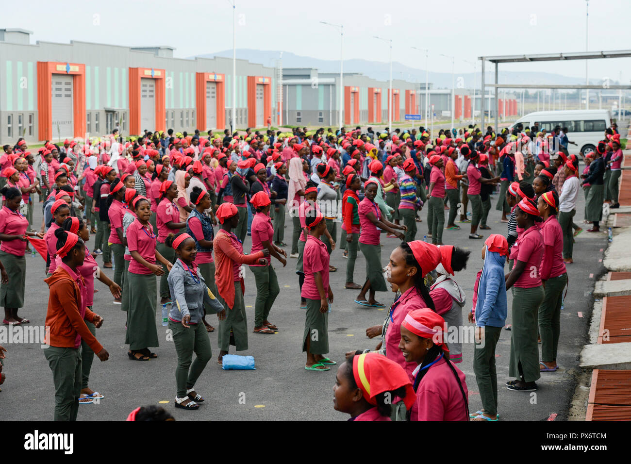 ETHIOPIA , Southern Nations, Hawassa or Awasa, Hawassa Industrial Park, chinese-built for the ethiopian government to attract foreign investors with low rent and tax free to establish a textile industry and create thousands of new jobs, taiwanese company Everest Textile Co. Ltd., women worker do a 15 minutes morning sports before work as motivation training Stock Photo