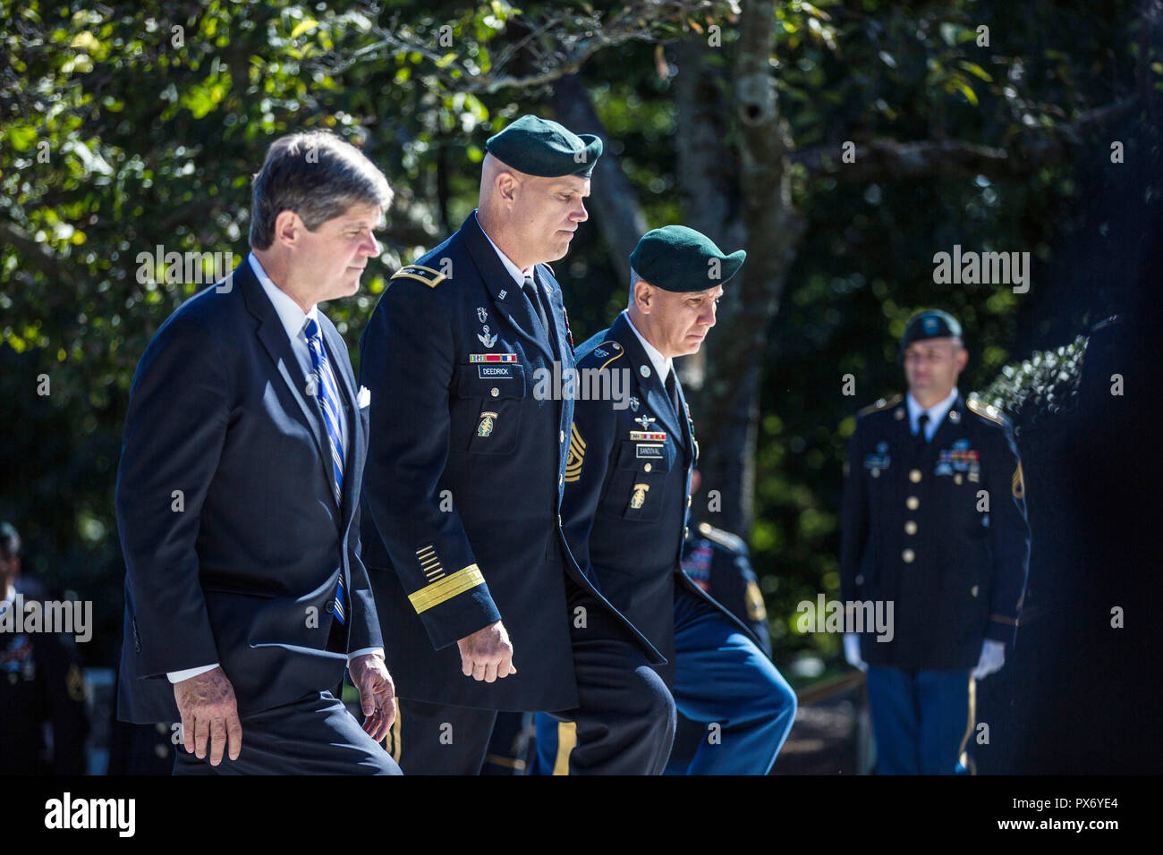 Dr. William Kennedy Smith, left, nephew of President John F. Kennedy joins U.S. Army Maj. Gen. John Deedrick, and Command Sgt. Maj. Tomas Sandoval, during a wreath ceremony at the gravesite of President Kennedy at Arlington National Cemetery October 17, 2018 in Arlington, Virginia. The annual ceremony pays tribute to vision of President Kennedy for creating a dedicated counter-insurgence force and his uncompromising support to the U.S. Green Berets. Stock Photo