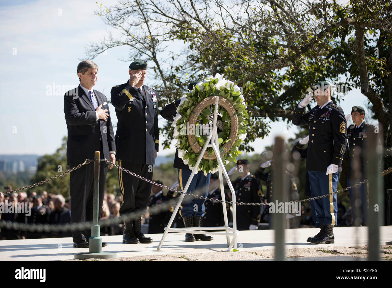 Dr. William Kennedy Smith, left, nephew of President John F. Kennedy joins U.S. Army Maj. Gen. John Deedrick, and Command Sgt. Maj. Tomas Sandoval, during a wreath ceremony at the gravesite of President Kennedy at Arlington National Cemetery October 17, 2018 in Arlington, Virginia. The annual ceremony pays tribute to vision of President Kennedy for creating a dedicated counter-insurgence force and his uncompromising support to the U.S. Green Berets. Stock Photo