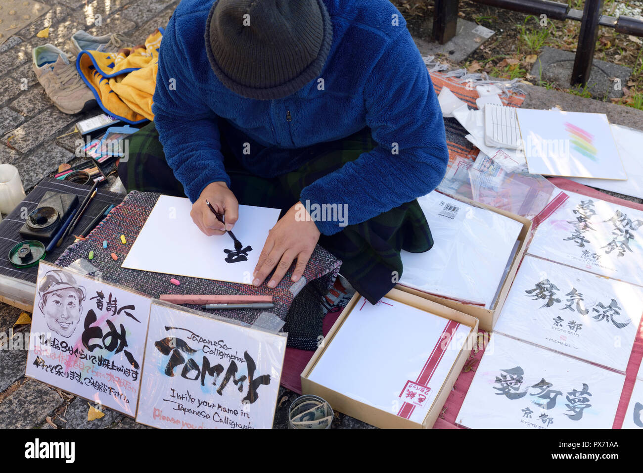 License available at MaximImages.com - Japanese street artist calligrapher writing people names in Kanji characters, Kyoto, Japan Stock Photo