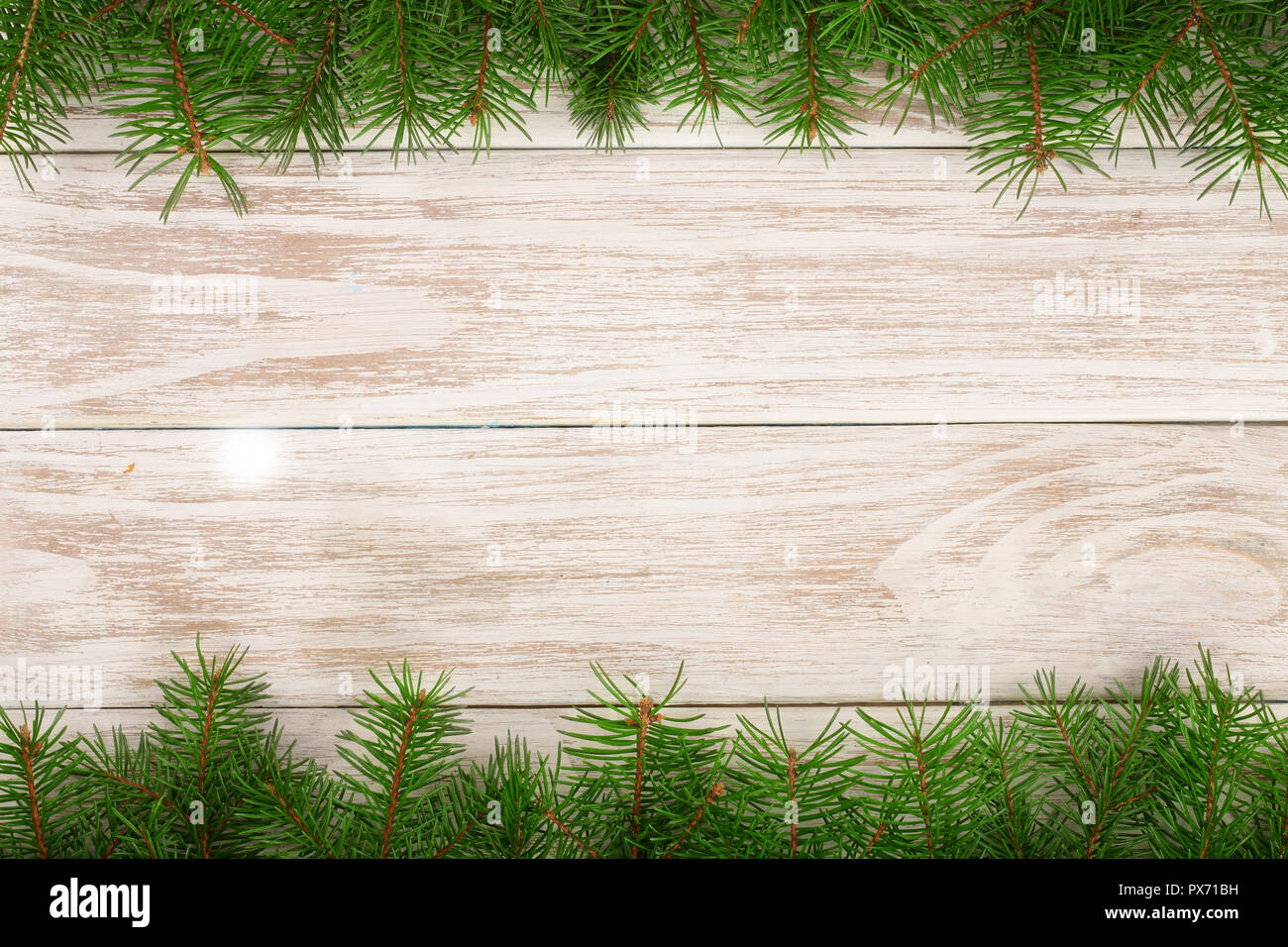 Christmas frame made of fir branches on a light wooden background Stock ...