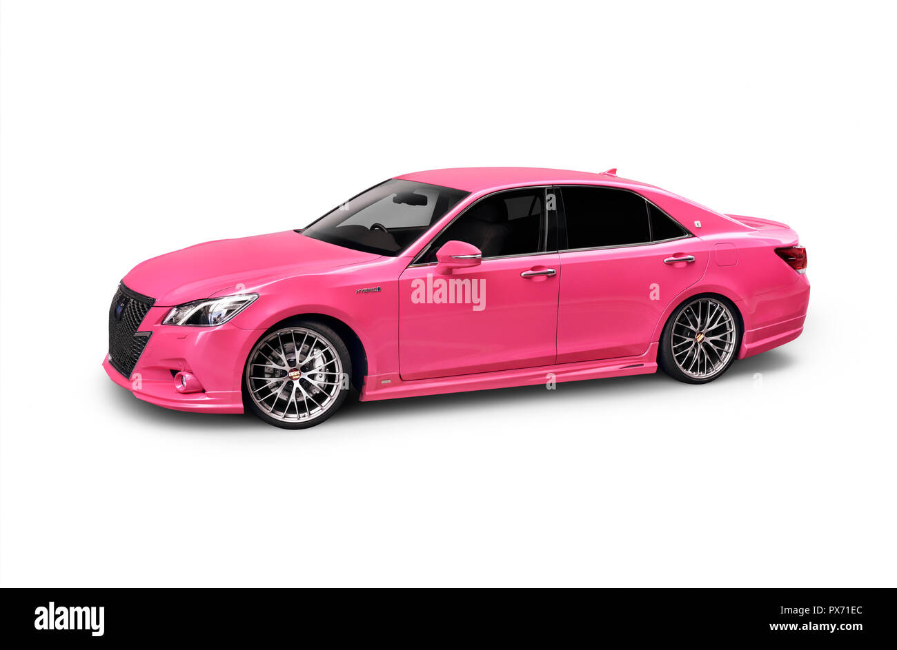 Bright pink 2017 Toyota Crown Athlete hybrid sedan Japanese luxury car isolated on white background with clipping path Stock Photo